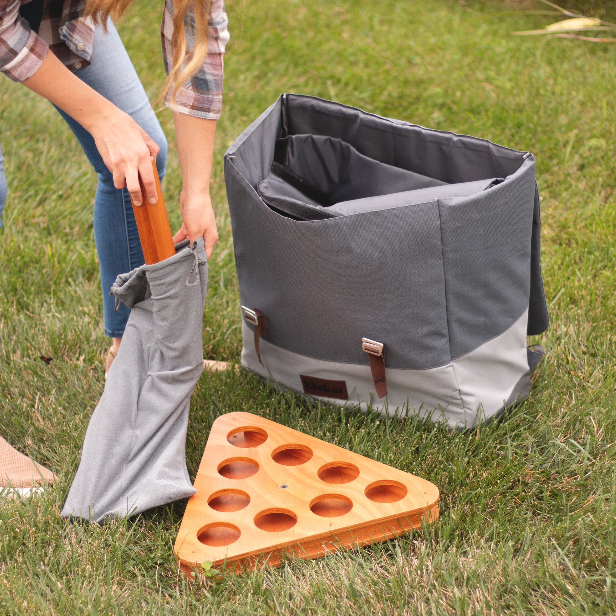 Person Putting Away Elakai Social Pong Set Into Carrying Bag